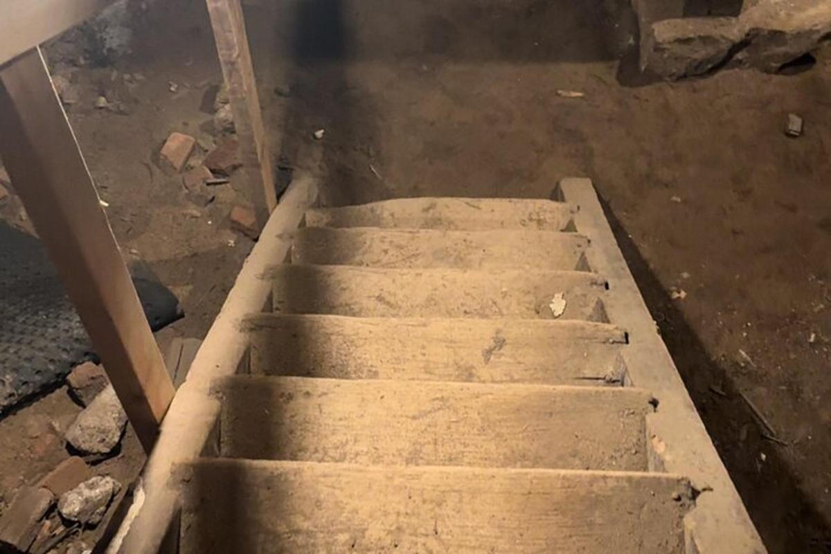a set of concrete stairs in a dirty room