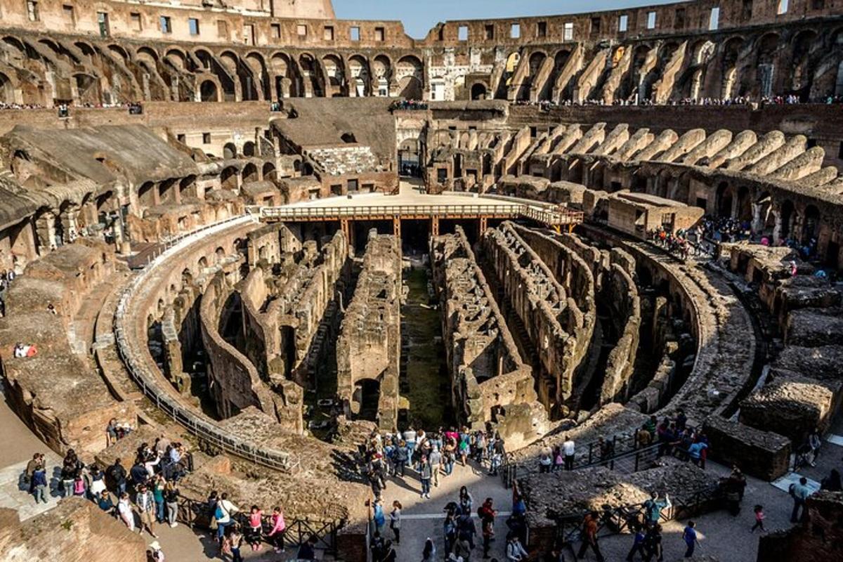 a group of people walking around the coliseum