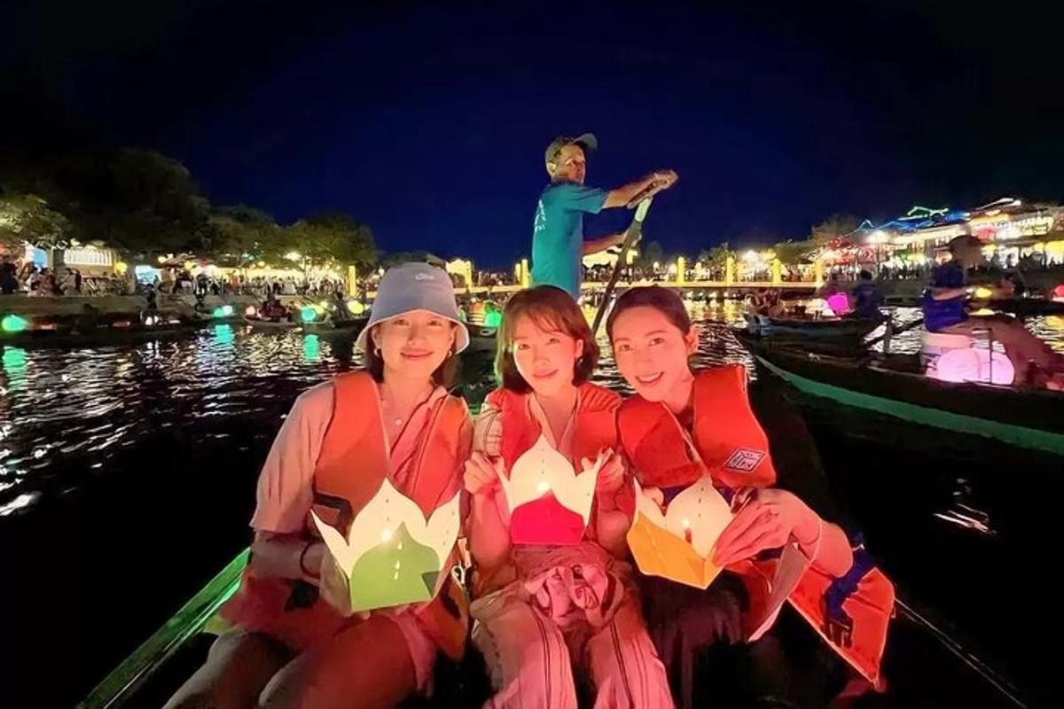 a group of women sitting on a boat at night