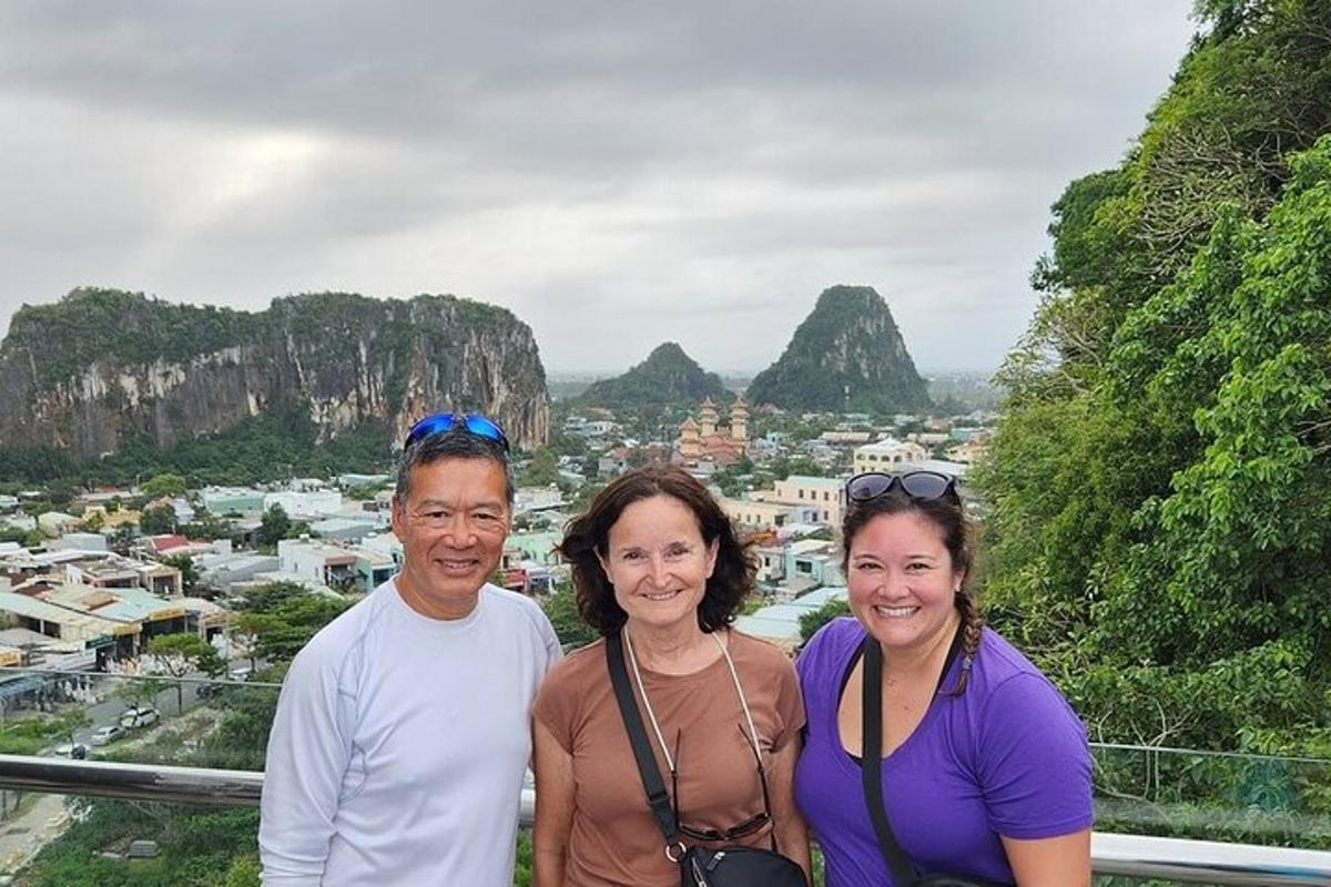 a group of three people standing on top of a mountain