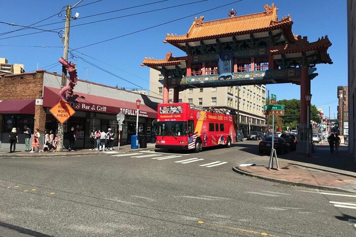 a red double decker bus driving down a city street