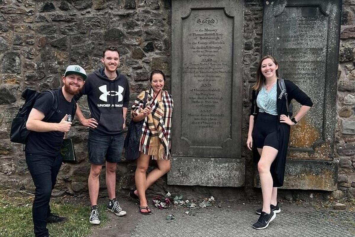 a group of people standing in front of a grave