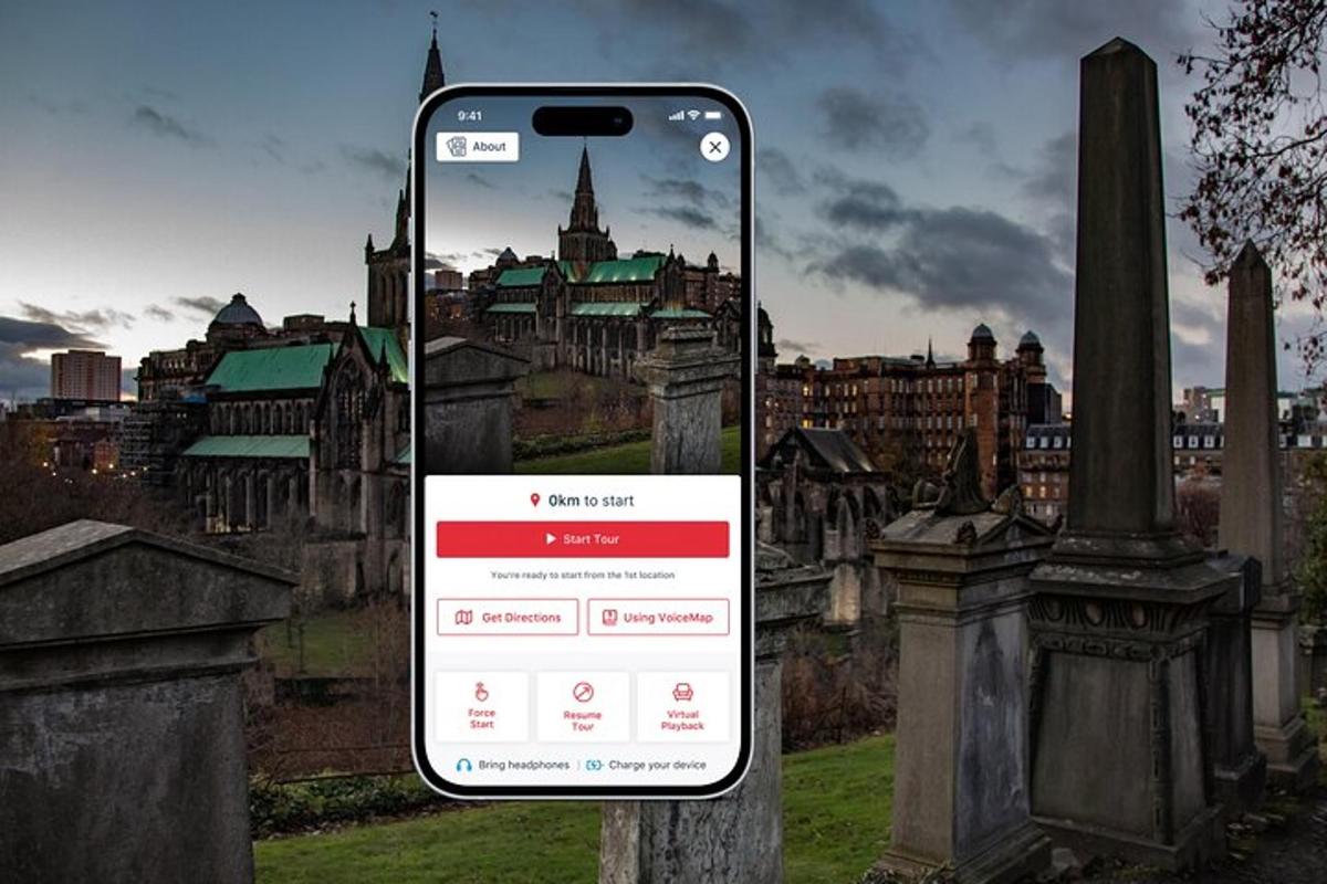 a cell phone in a cemetery with a city in the background