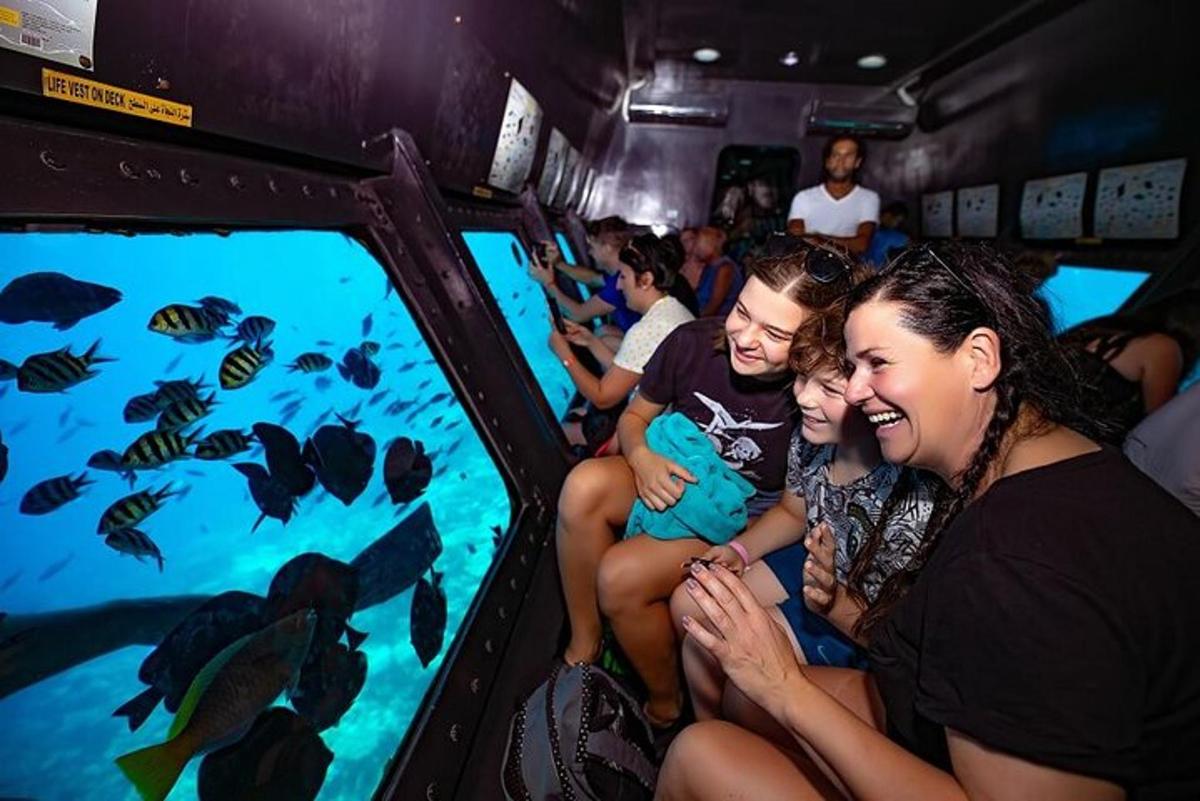 a group of people looking at fish in an aquarium
