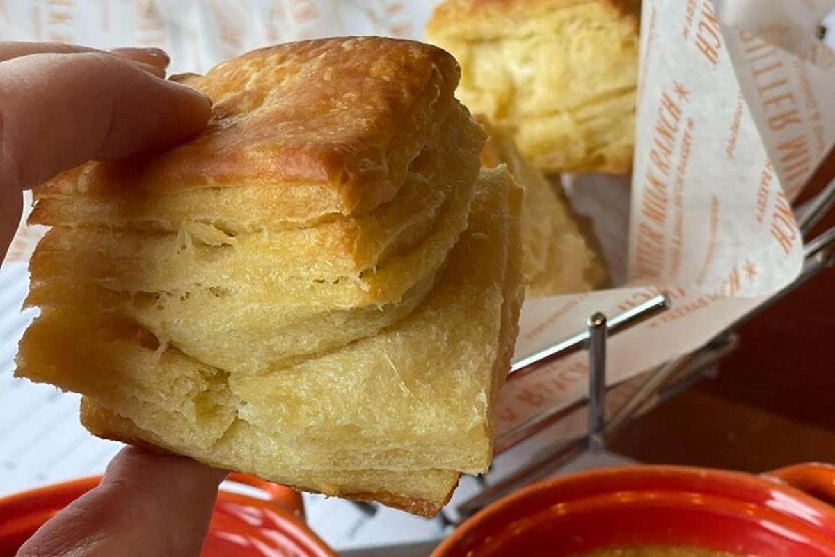 a person is holding a piece of bread