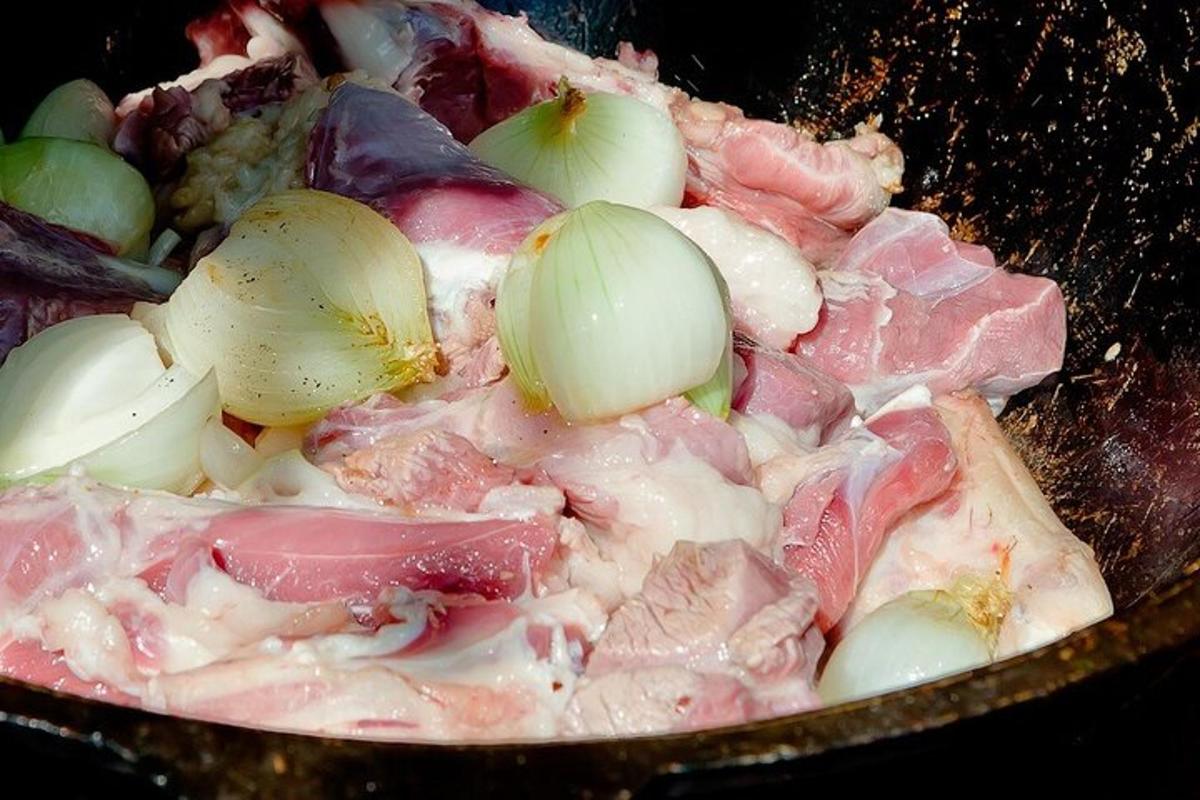 a bowl of food with meat and onions