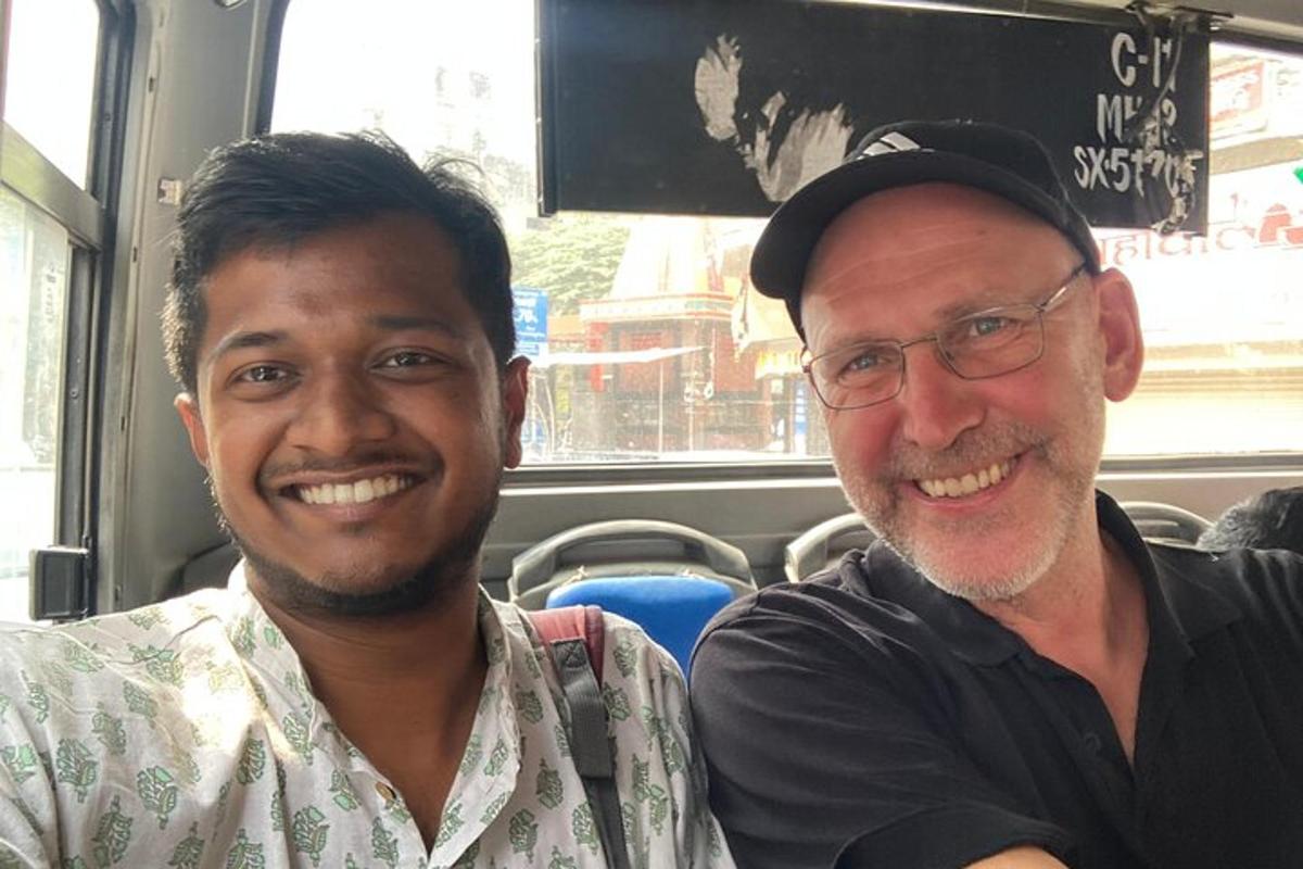 two men are sitting on a bus