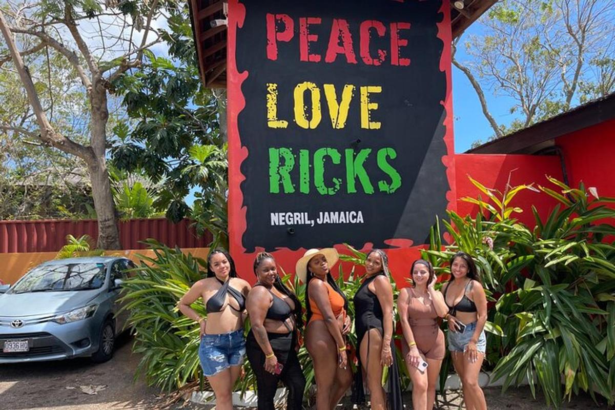 a group of women in bathing suits standing in front of a sign