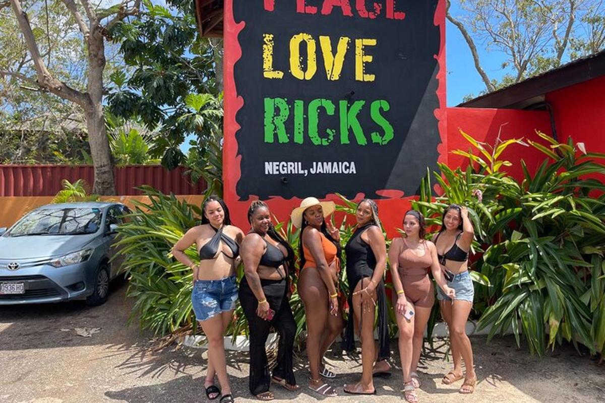 a group of women in bathing suits standing in front of a sign