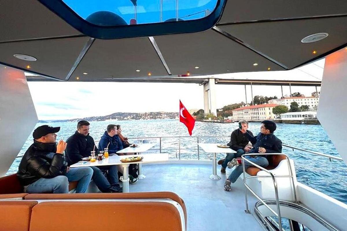 a group of people sitting at tables on a boat