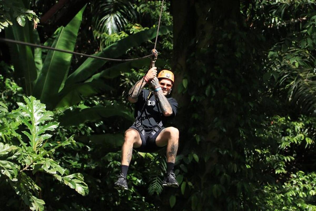 a man riding on a zip line in the jungle