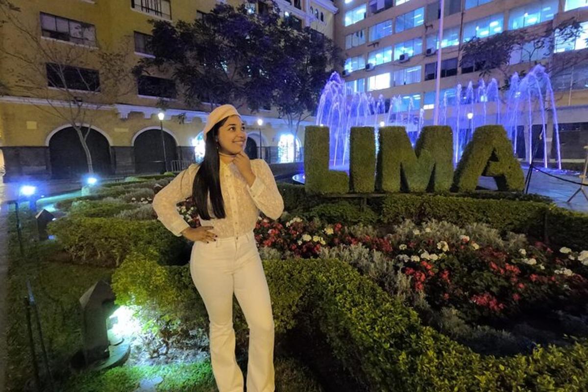 a woman is standing in front of a fountain
