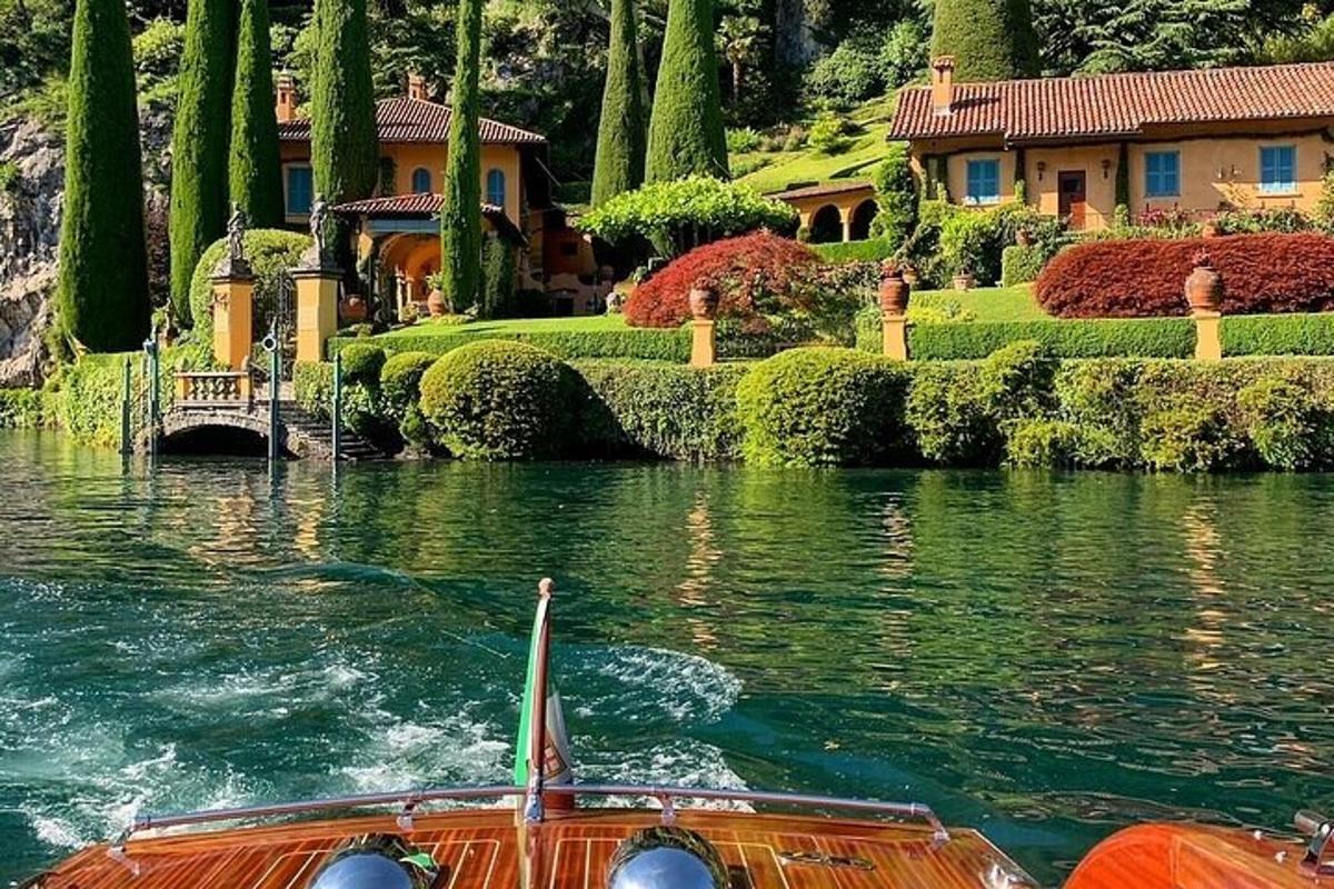 a boat in the water in front of a house