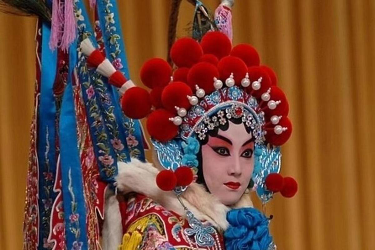 a woman in a costume with a bunch of red flowers