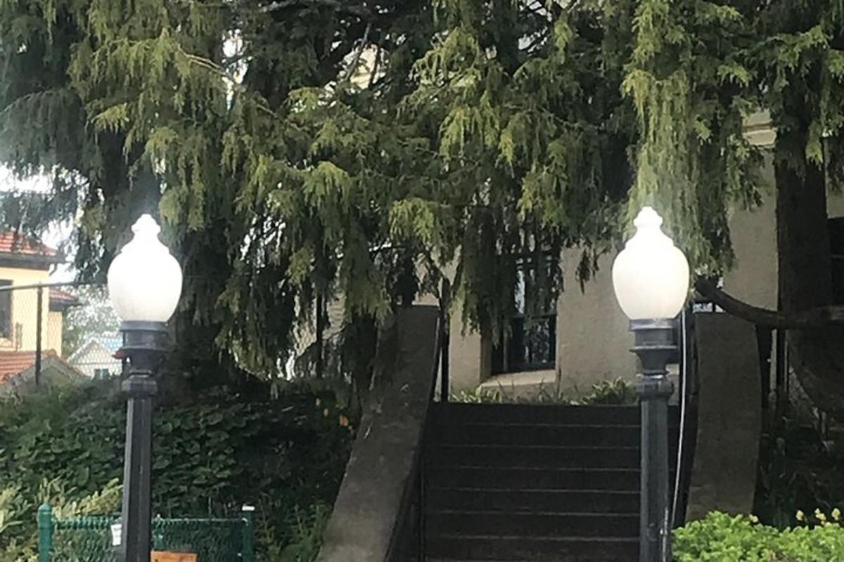 two lights in front of a building with a staircase
