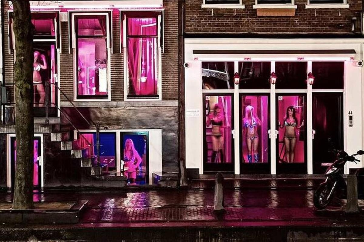 a store front with pink lights in the windows