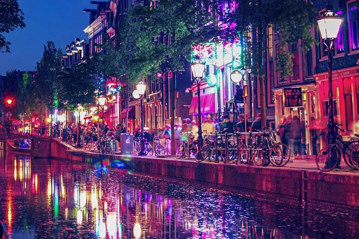 a group of bikes parked next to a river at night