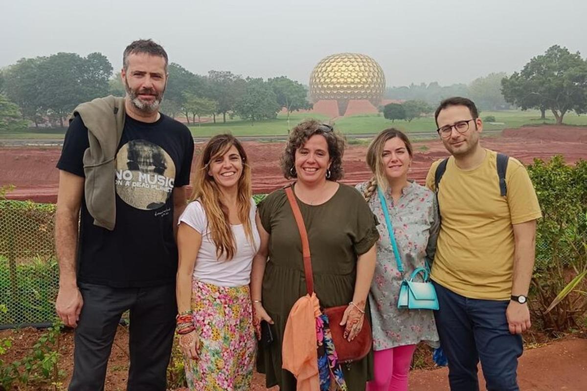 a group of people posing for a picture in front of a field