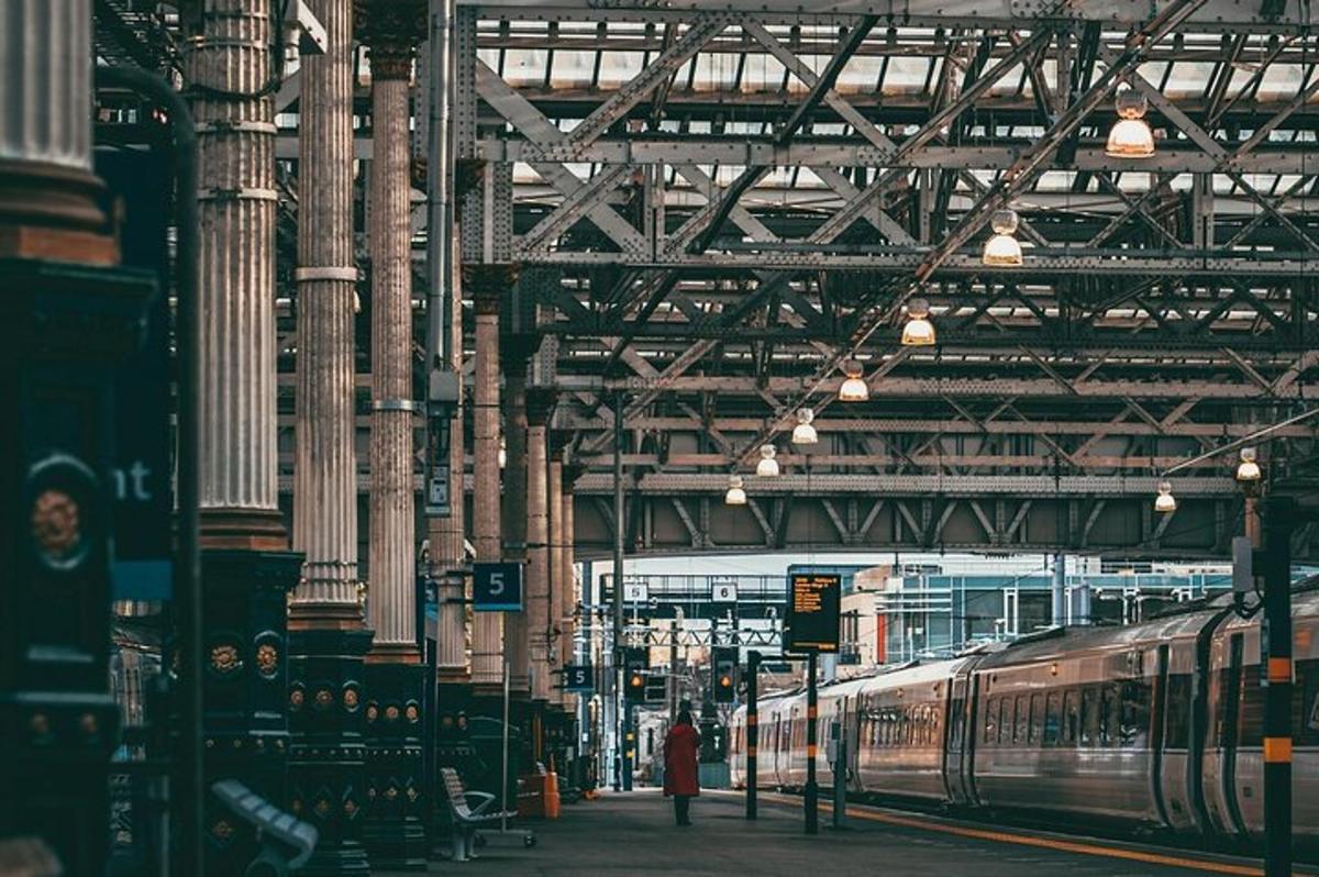 a train station with a woman standing next to a train