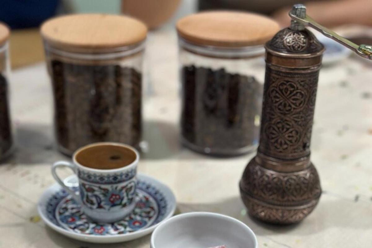 a table with a cup of coffee and three jars