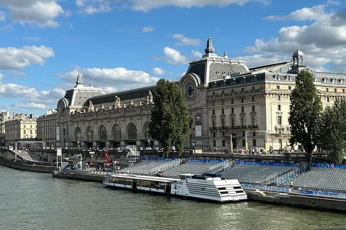 a large building next to a river with a boat