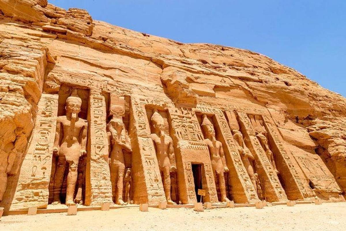 a building with statues on the side of a cliff