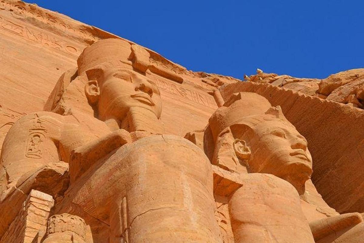 a sand sculpture of two heads on the side of a building