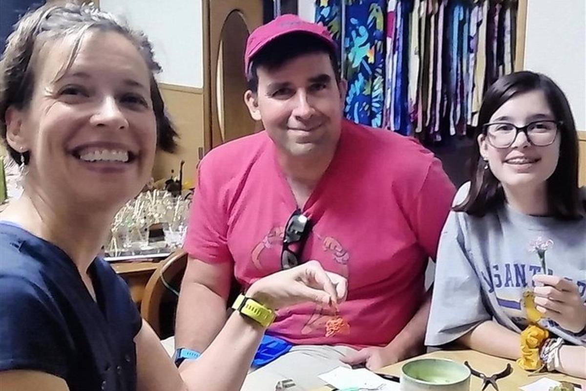 a man and two women sitting at a table