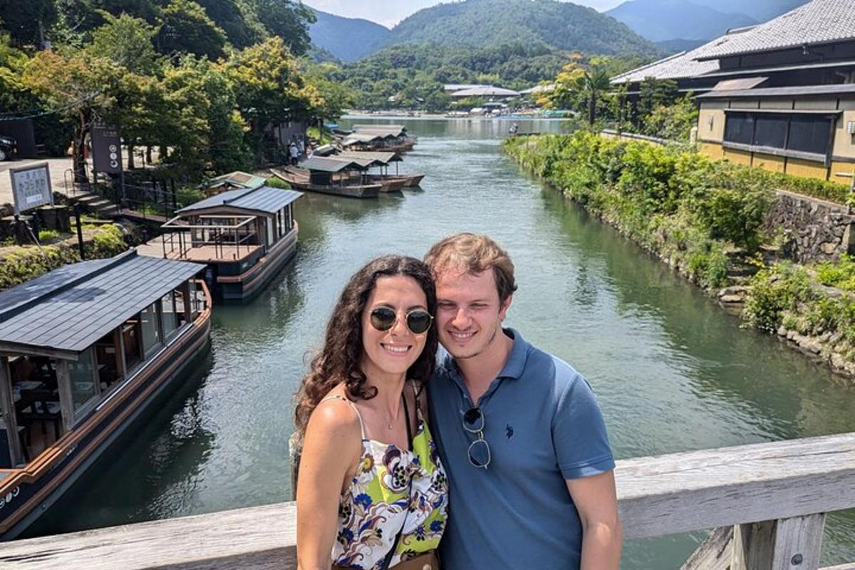 a man and woman standing on a bridge next to a river