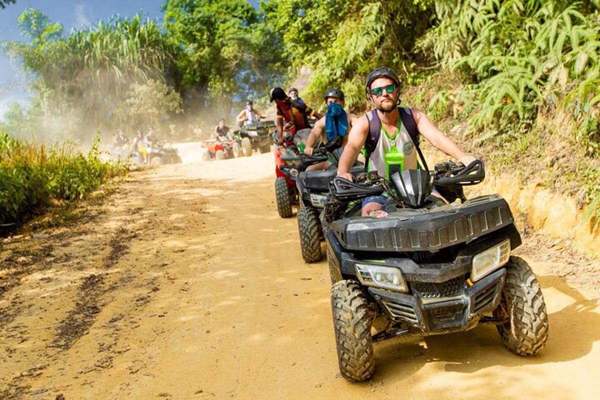 un gruppo di persone che guidano quad su una strada sterrata