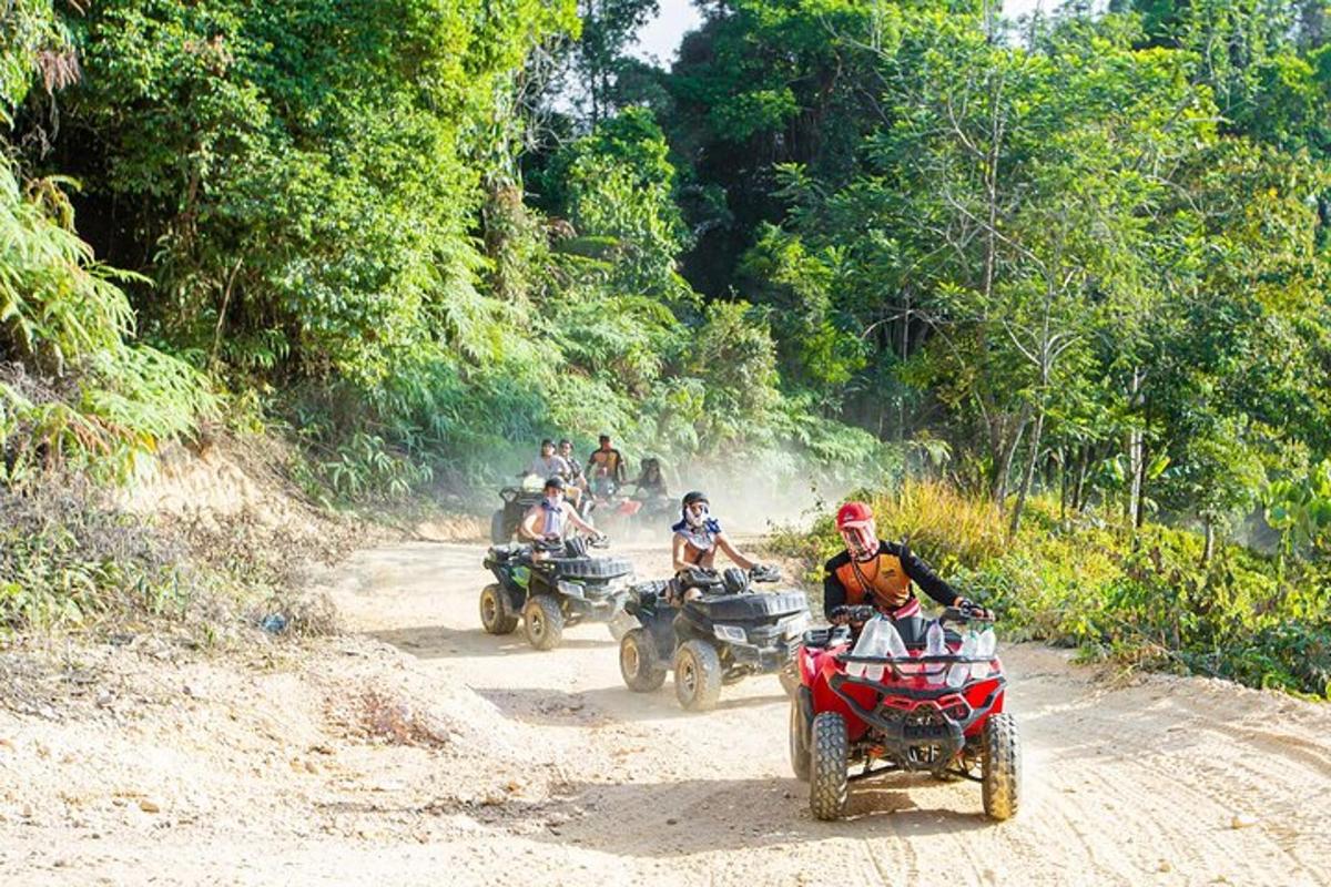 un gruppo di persone che guidano quad su una strada sterrata