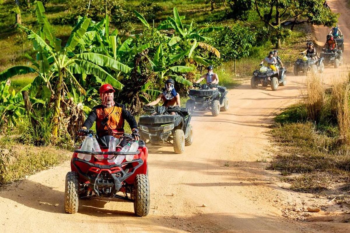 un gruppo di persone che guidano quad su una strada sterrata