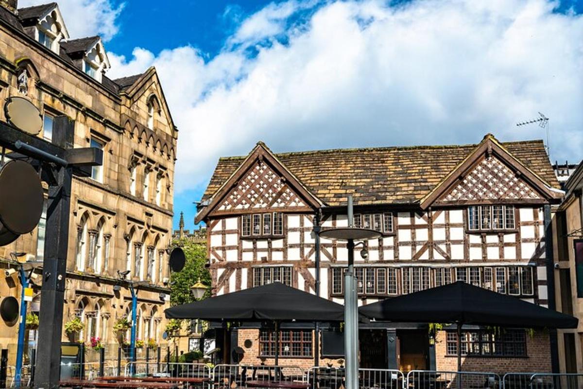 an old building with tables and umbrellas in front of it
