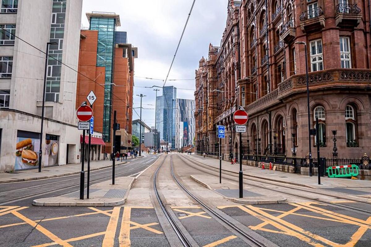 an empty street with train tracks in a city