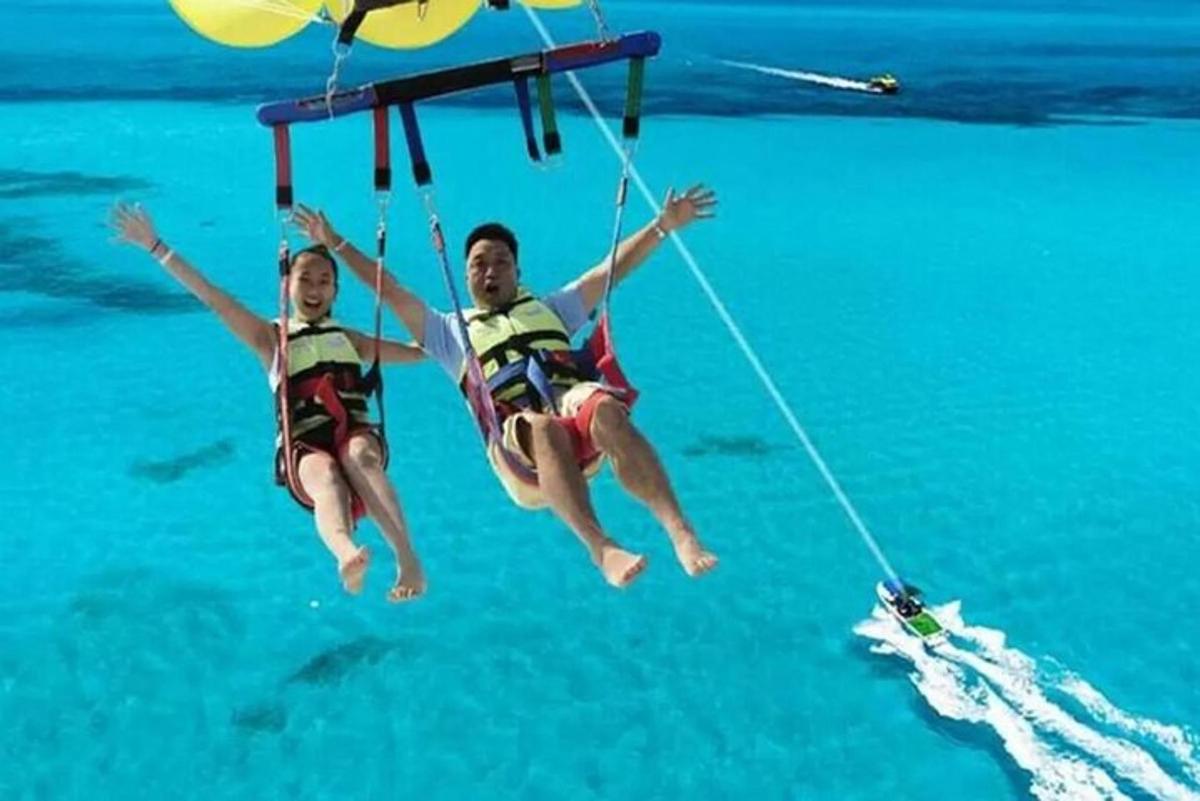 two people on a rope swing in the water