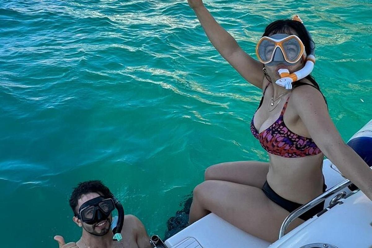 ženska v bikiniju sedi na čolnu v vodi