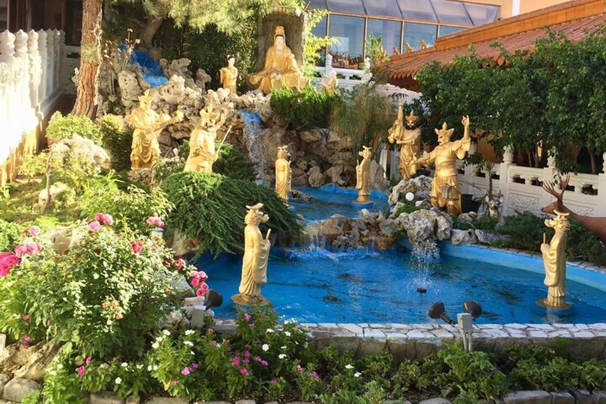 a garden with statues in the middle of a fountain