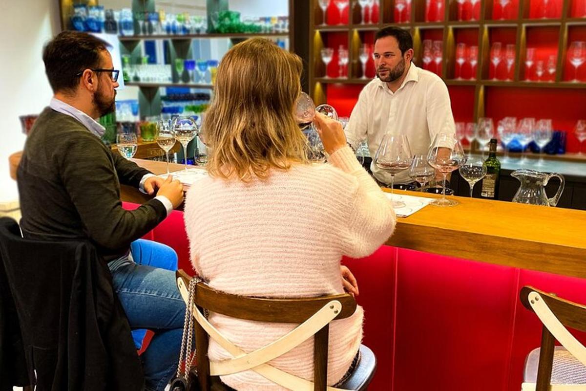 a woman sitting at a bar with two men