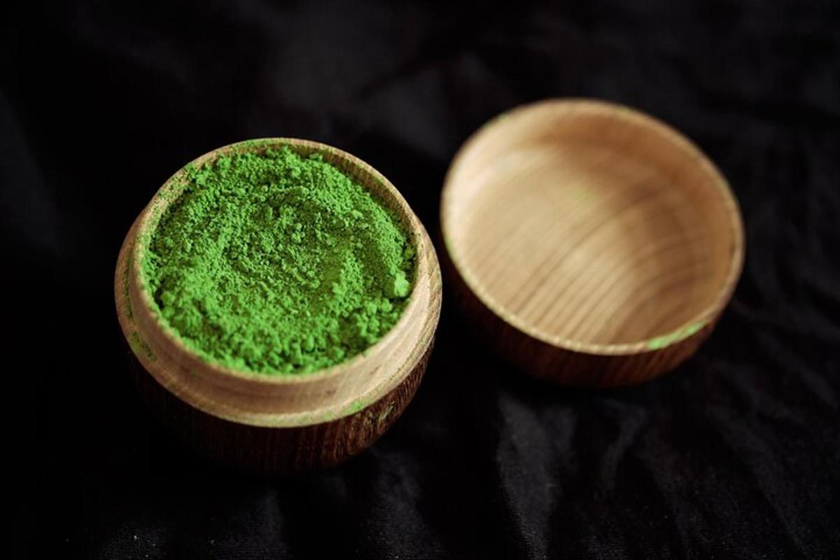 two wooden bowls filled with green substance on a table
