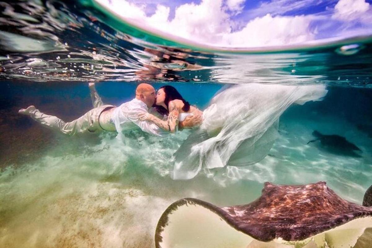 a bride and groom swimming in the water