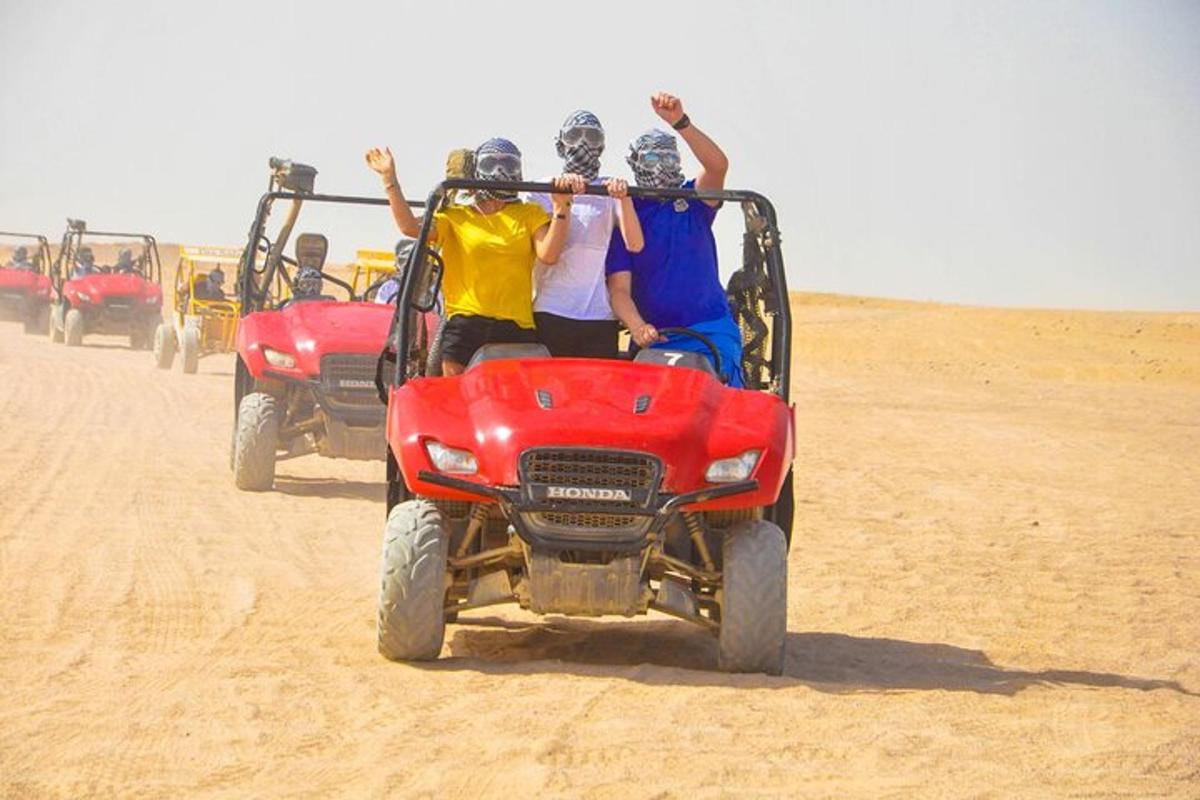 a group of people riding on a four wheeler in the desert