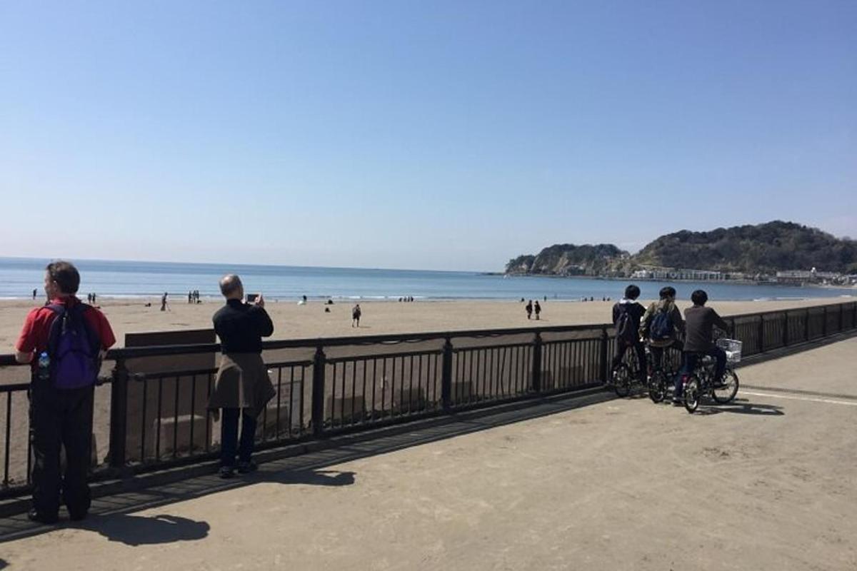a group of people taking pictures of the beach