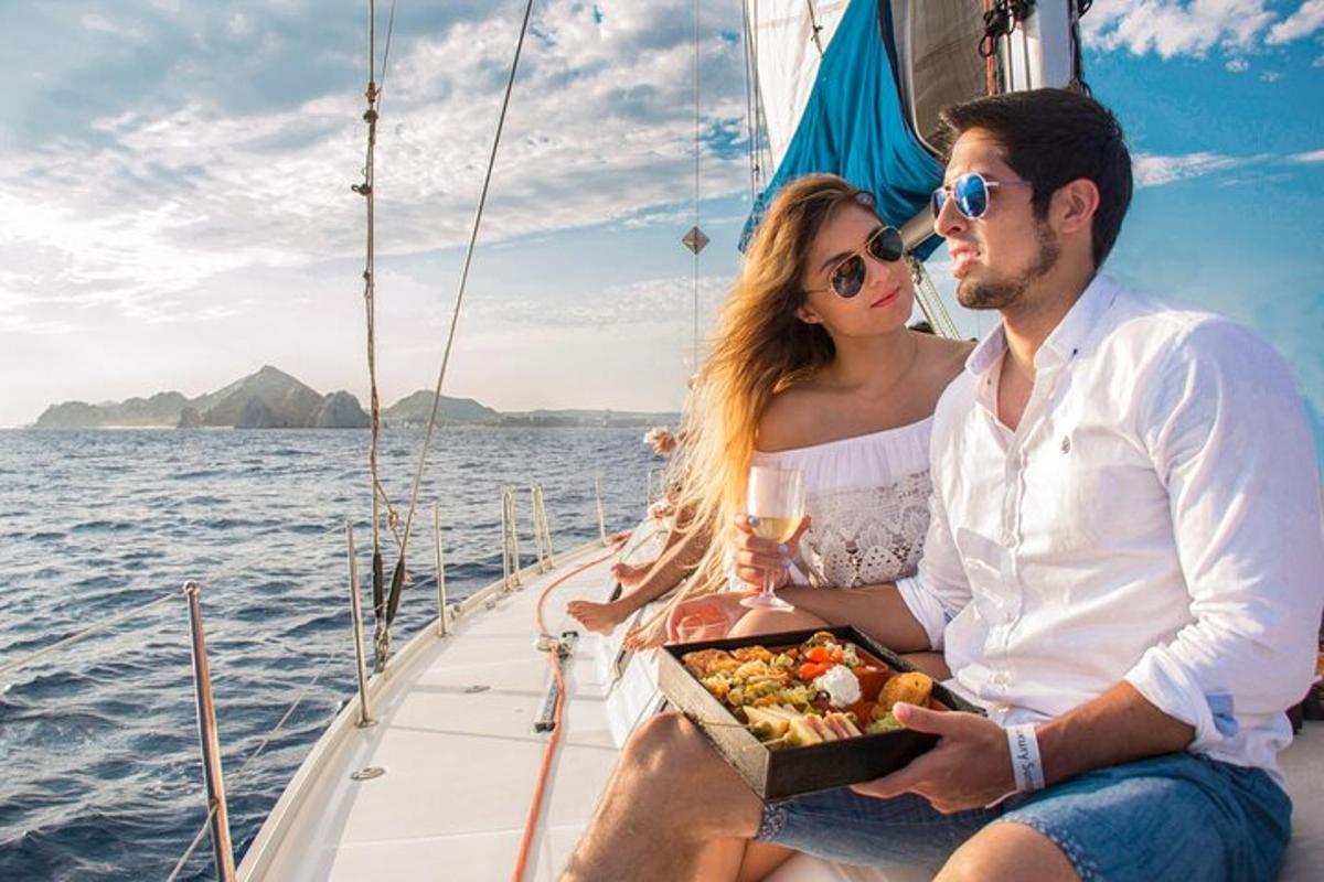a man and woman sitting on a boat with a box of food