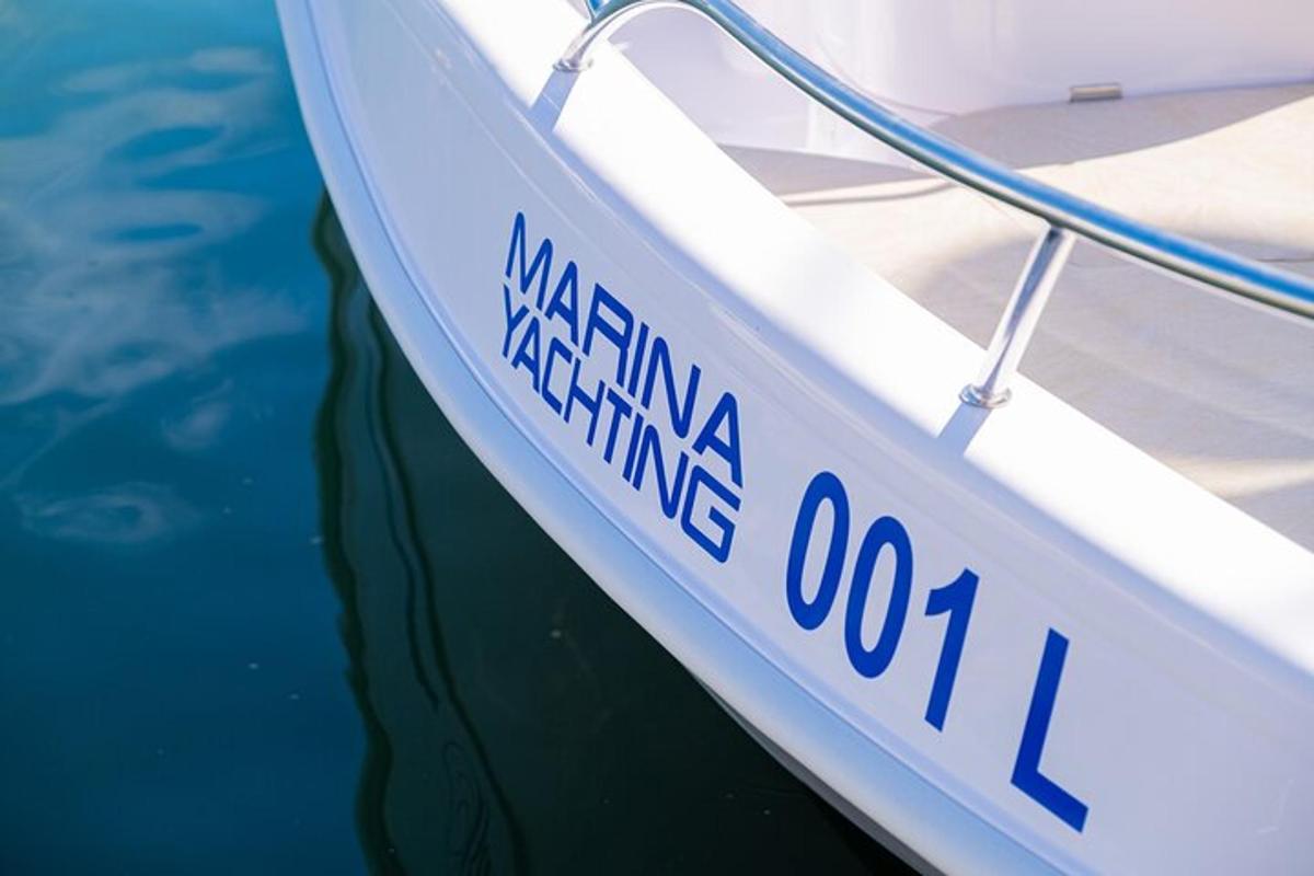 a white boat is sitting in the water