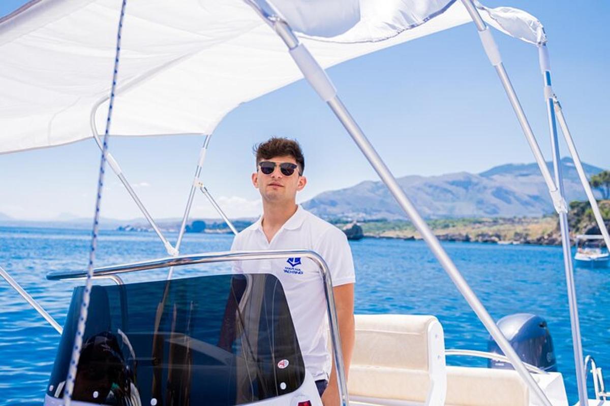a man standing on a boat in the water