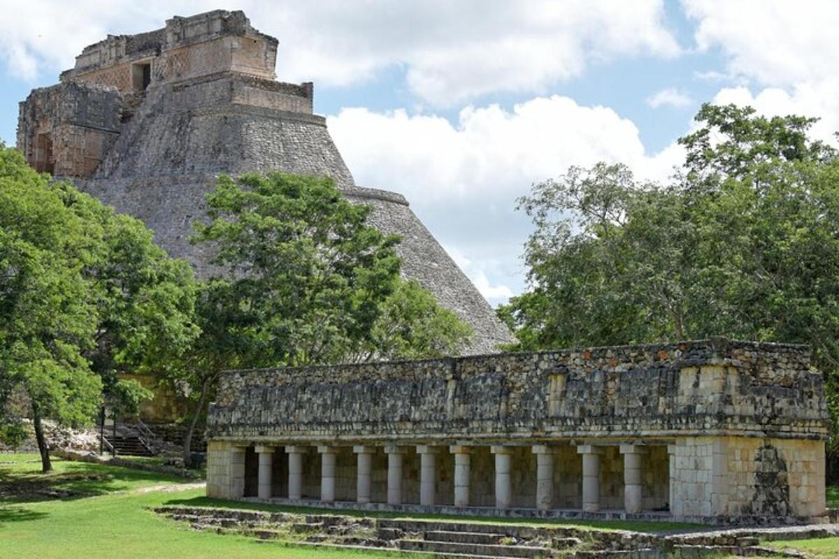 a pyramid and a building with trees in the background