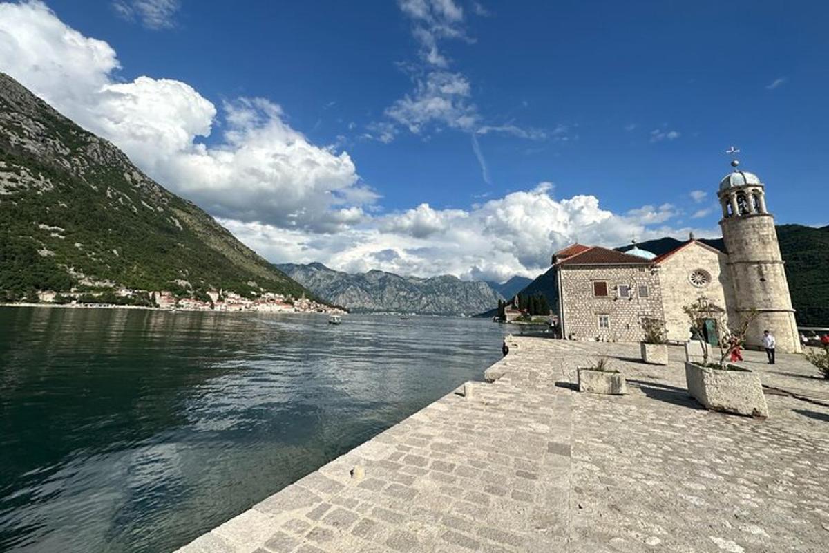a building next to a body of water with a lighthouse
