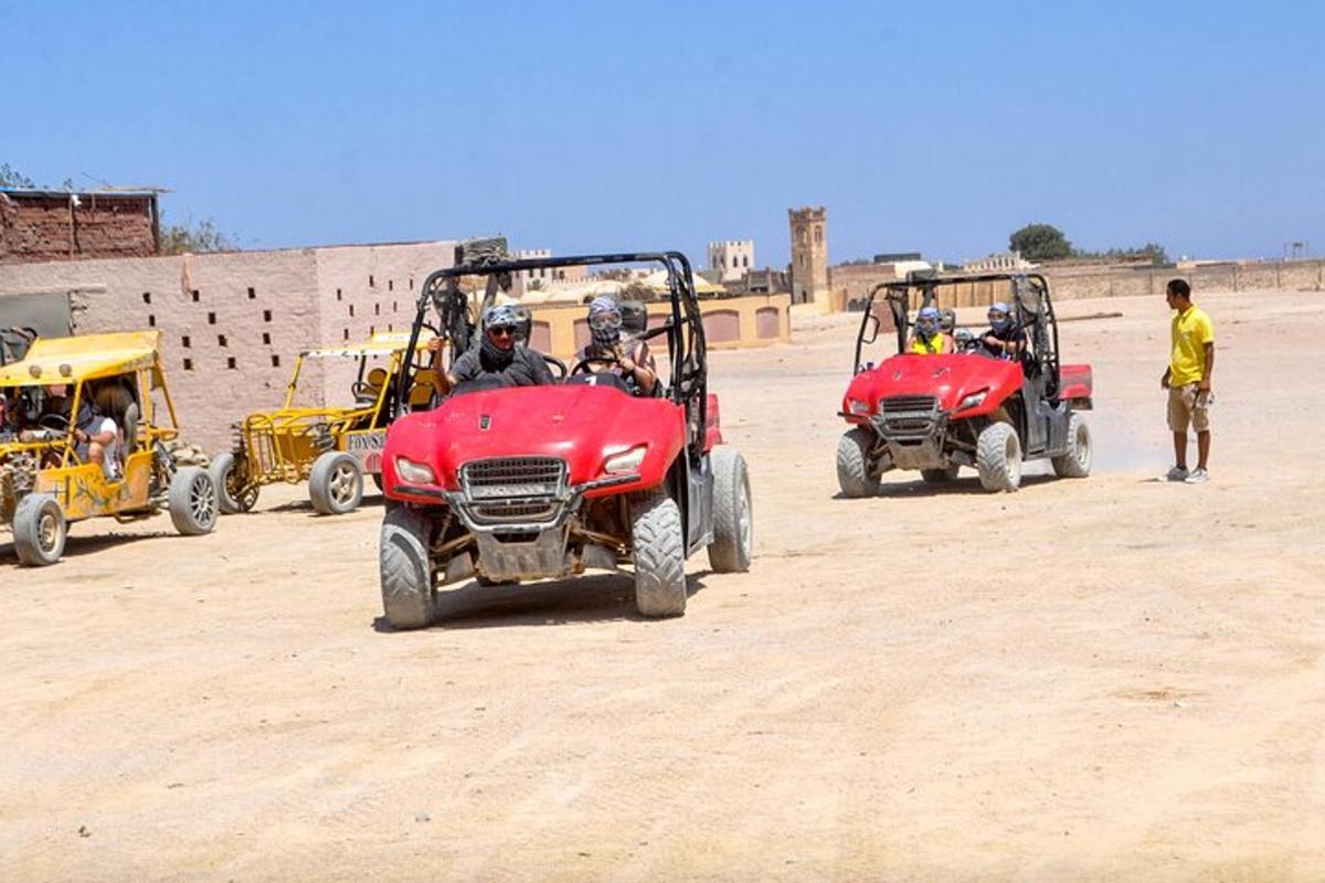 um grupo de pessoas andando de quadriciclo no deserto