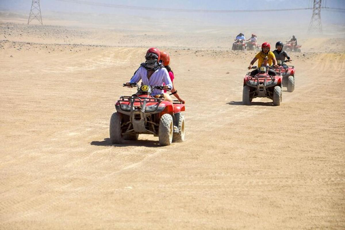 a group of people riding on atvs in the desert