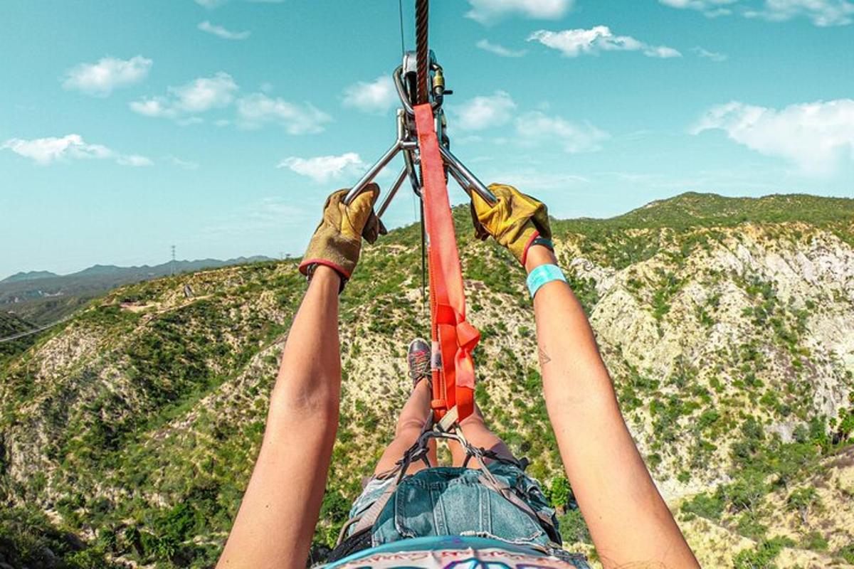 two people are hanging on a zip line